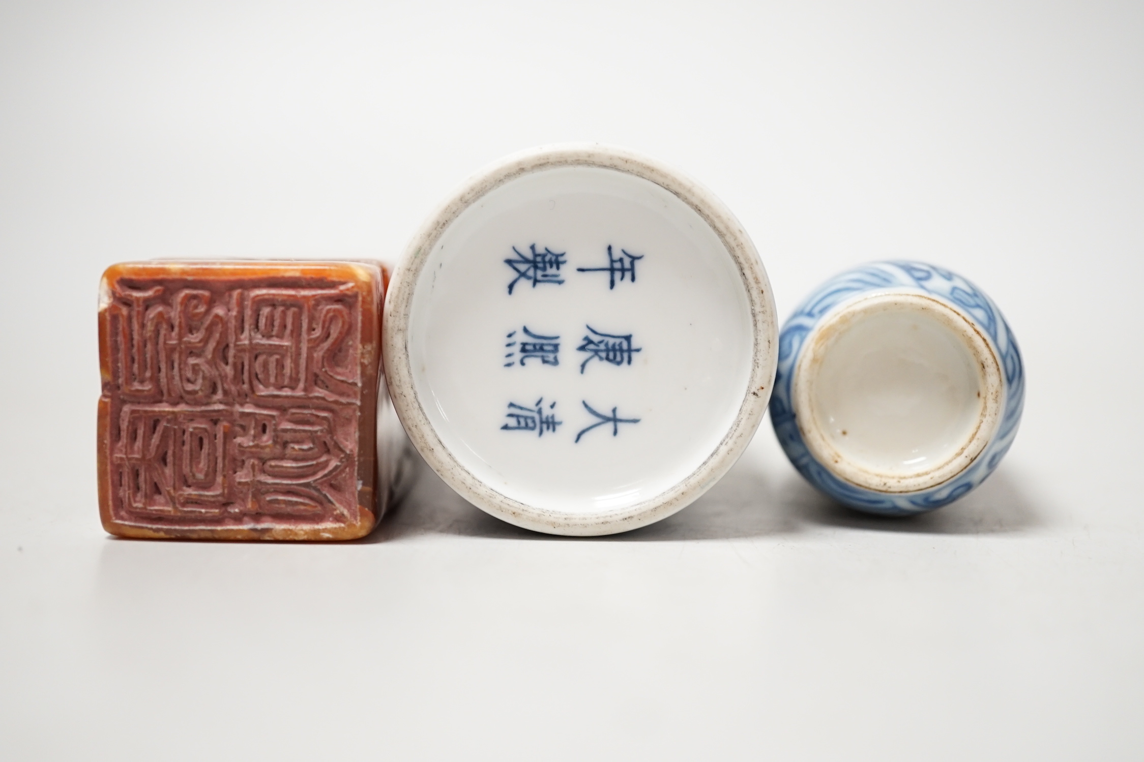 Two Chinese porcelain snuff bottles and a Chinese soapstone seal, 12.7cm